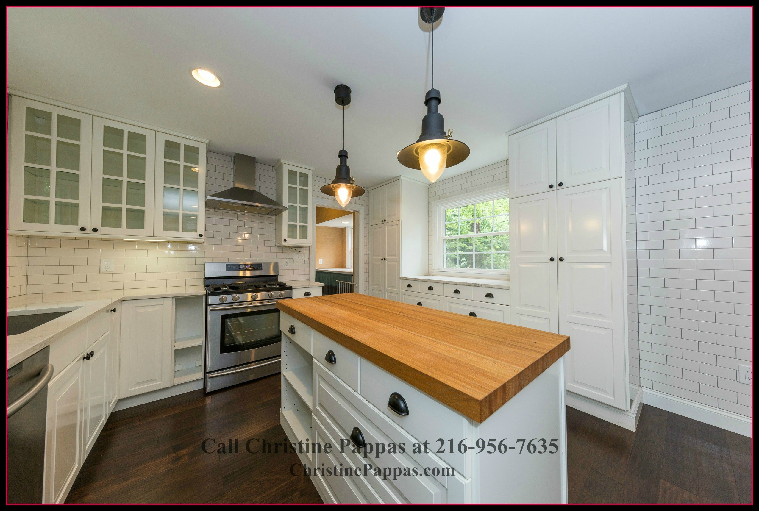 The gourmet kitchen in this strikingly beautiful home for sale in Gates Mills OH features center island and built in cabinets that add up to the elegance of the interiors.